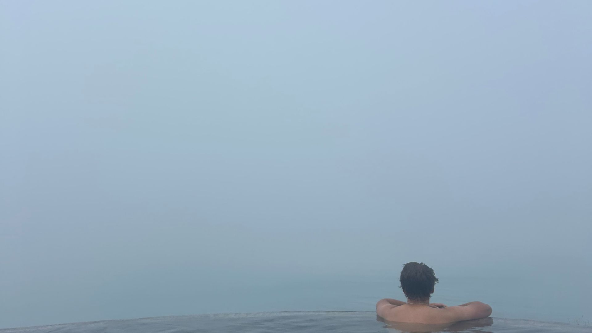 Seth looking over the edge at Geosea Geothermal Sea Baths in Iceland